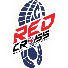 Brown leather key ring with brass metal loops and rivets on wood table.